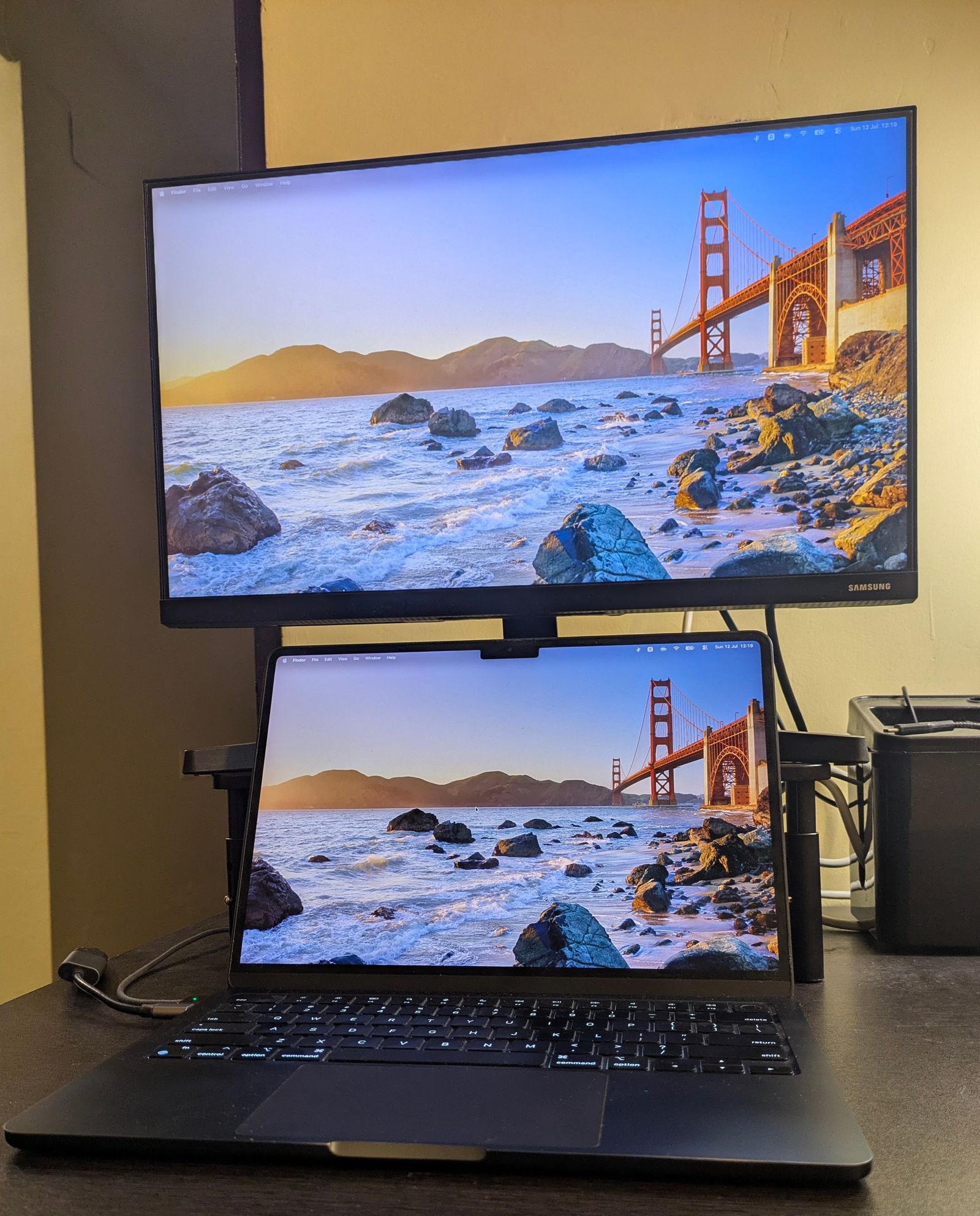 Laptop, monitor, and monitor stand setup on my desk